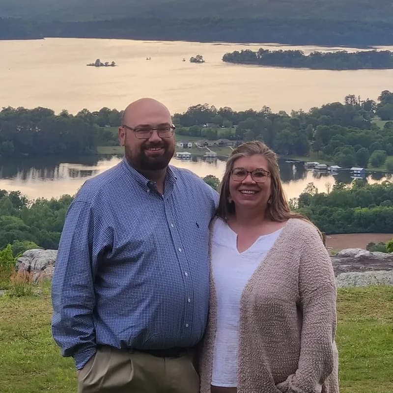 Pastor Blake Hughes and his wife, Anastasia, standing on an overlook above a lake